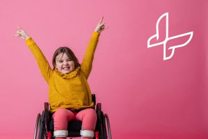 A smiling young girl in a wheelchair